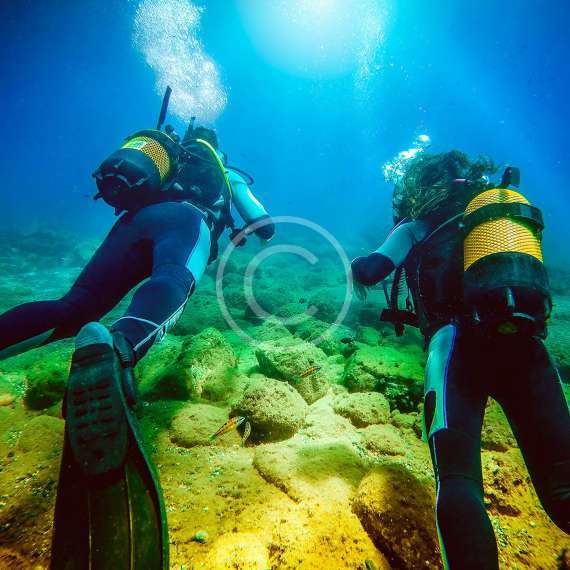 An expert scuba diver with a student