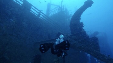 A diver beside a ship