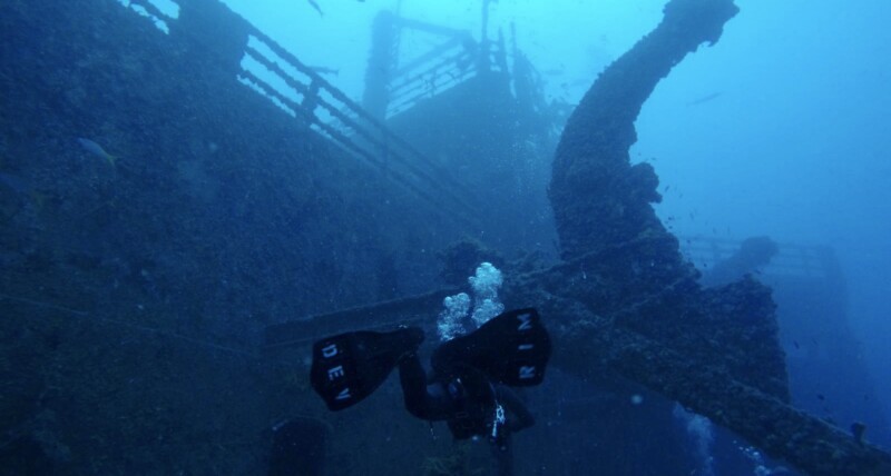 A diver beside a ship